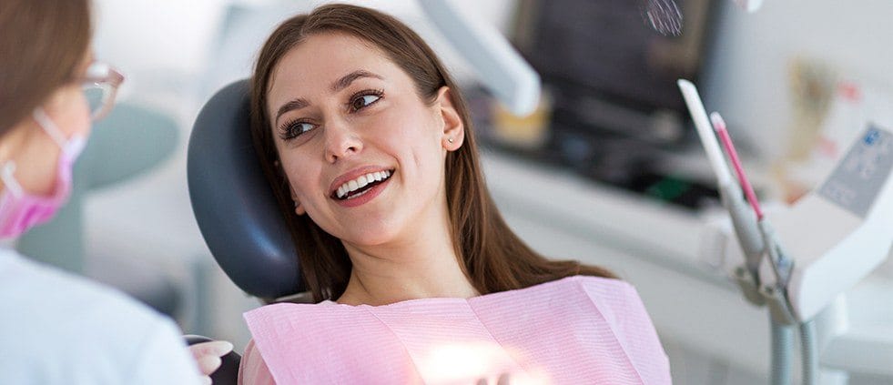 Smiling woman in dental chair during preventive dentistry visit
