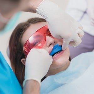 Dental patient receiving fluoride treatment