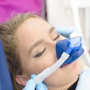 Dental patient with nitrous oxide sedation dentistry nasal mask