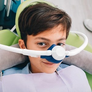 Young boy receiving nitrous oxide dental sedation from sedation dentist in Lincoln