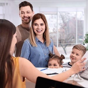 Father mother and two children at reception desk