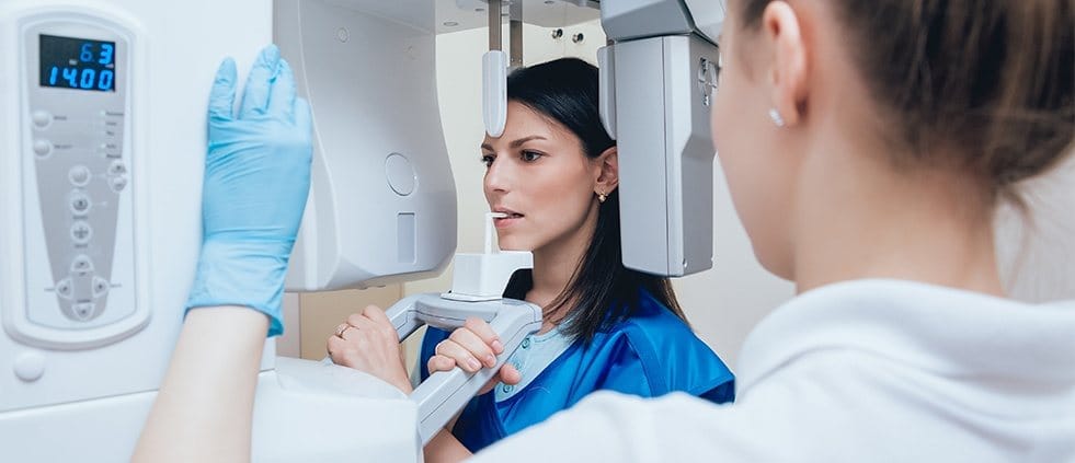 Woman receiving 3 D C T cone beam x ray scan