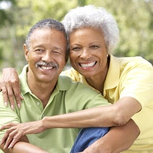 An older couple hugging and smiling