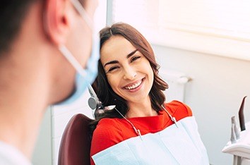 Dental patient smiling at her dentist