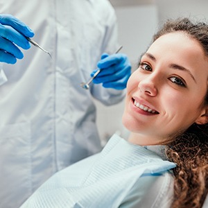 Woman smiling as dentist approaches