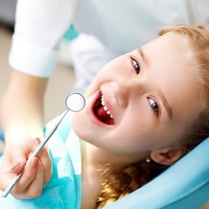 A young girl having her teeth checked at the dentist