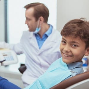 A young boy in the dental chair visiting kid friendly dentist