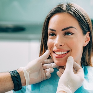 Lincoln cosmetic dentist examining patient's smile
