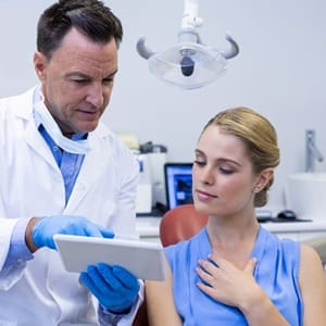 Dental patient talking to her dentist about dental crowns