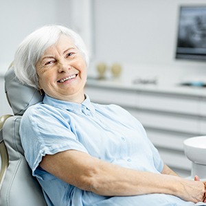 Happy senior woman glad she could afford dentures