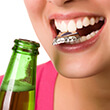Woman holds bottle cap between her teeth