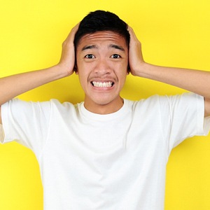 Stressed man has questions with yellow background