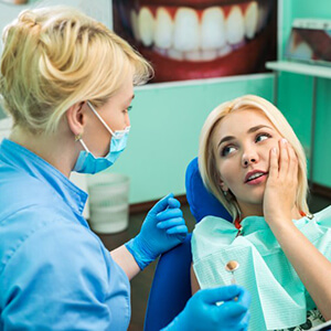 Woman with toothache visiting her Lincoln emergency dentist