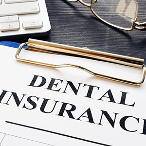 Dental insurance form on a clipboard on a desk