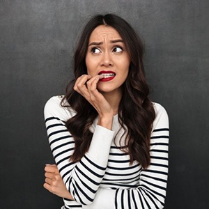 Woman nervously chewing on her fingernails