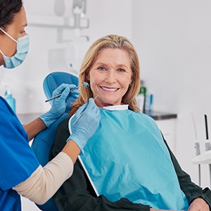 A woman getting implant dentures