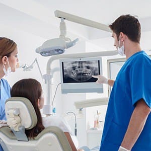 Dentist and dental patient discussing advanced dental implant procedures