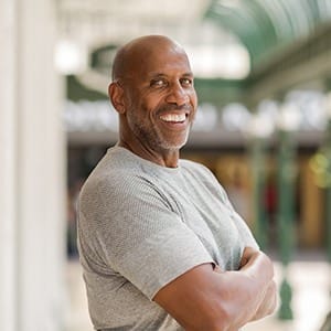 Confident man smiles with dental implants in Lincoln