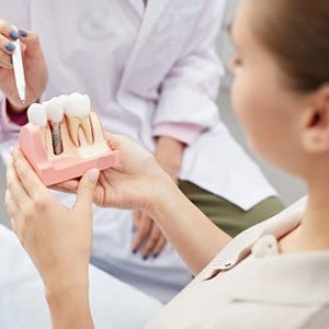 Dentist explaining how dental implants work in Lincoln