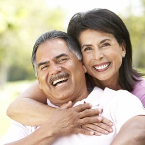 Laughing couple with dental implants in Lincoln