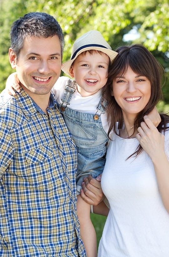 Smiling mother father and child outdoors