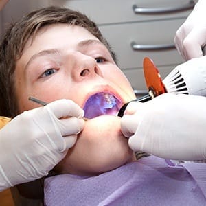 Patient receiving dental sealants