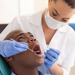 Man receiving oral cancer screening