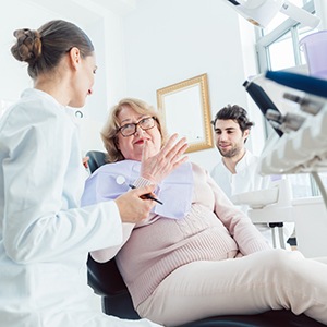 Dentist and patient conversing with each other