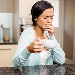 person holding a cup with a toothache