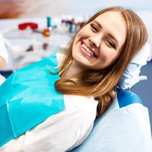 person smililng in dentist’s chair