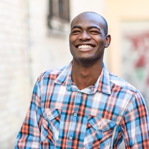 Man walking in the city and smiling