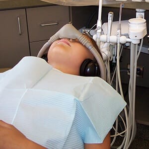 Child receiving nitrous oxide sedation dentistry treatment