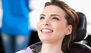 Smiling woman in dental chair for preventive dentistry visit