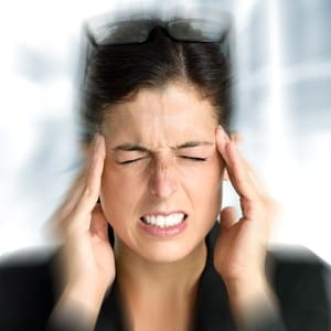 A woman with an intense headache from untreated T M J disorder