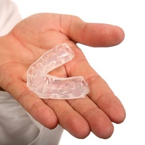 A person holding an occlusal splint