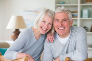 older couple smiling with dental implants in Lincoln 