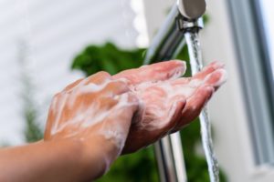 Lincoln dentist washes their hands during the COVID-19 pandemic