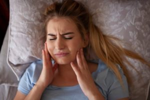 Woman suffering from pain due to facial swelling.