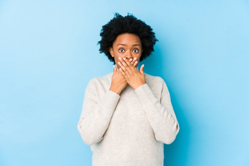 A woman hiding her small teeth