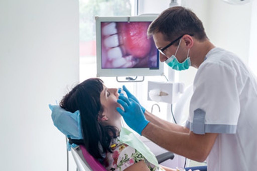 person having a dental crown replaced