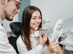 Dentist showing patient veneers. 