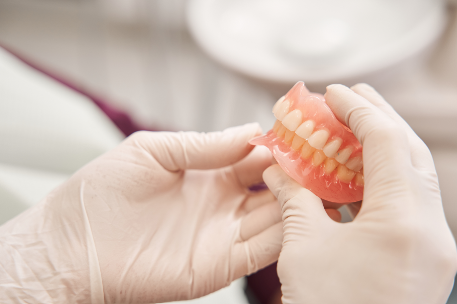 Dentist holding dentures