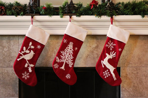 Three stockings hanging over a fireplace