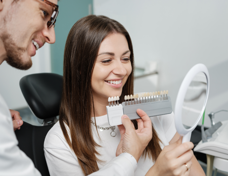 Dentist showing patient veneer options
